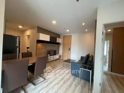 Modern living room with dining area and sleek wooden flooring