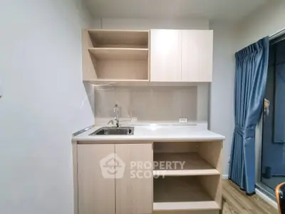 Modern compact kitchen with sleek cabinetry and stainless steel sink