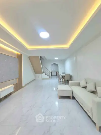 Spacious modern living room with elegant lighting and sleek marble flooring