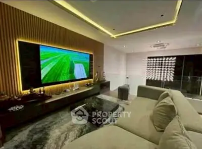 Luxurious modern living room with large TV and elegant decor