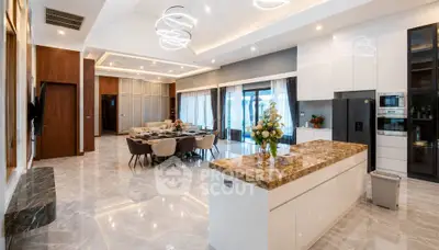 Luxurious open-plan kitchen and living area with marble floors and modern lighting