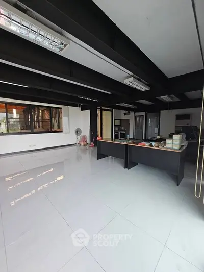 Spacious modern office space with sleek design and ample natural light.