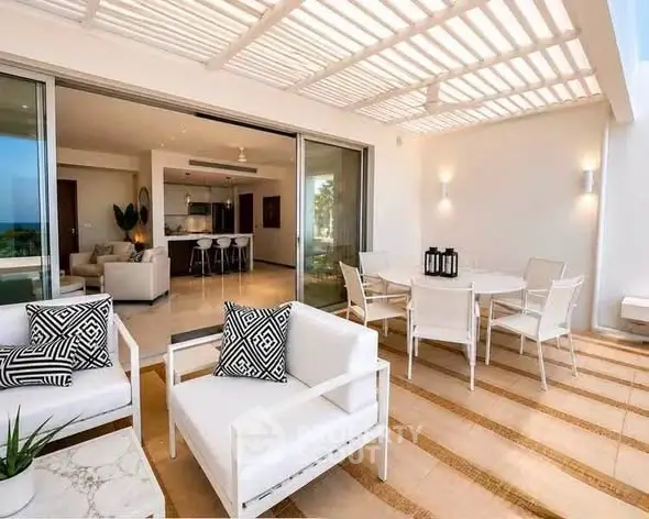 Luxurious open-plan living room with elegant outdoor terrace and modern furniture.