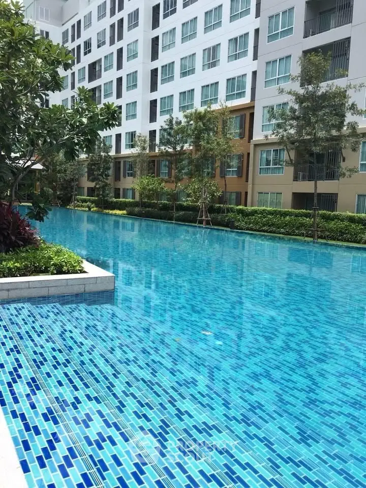 Luxurious residential building with stunning pool and lush greenery