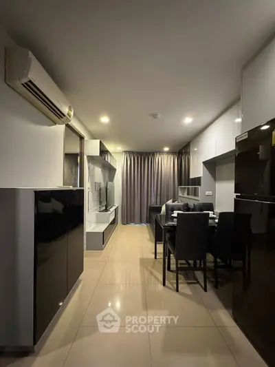 Modern living room with dining area and sleek black furniture, featuring air conditioning and elegant lighting.