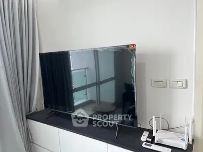 Modern living room with sleek TV and balcony view