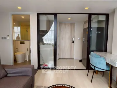 Modern apartment interior with open layout, featuring a cozy living area and sleek bathroom.
