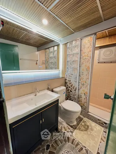 Charming bathroom with unique tile design and modern fixtures, perfect for a cozy home retreat.