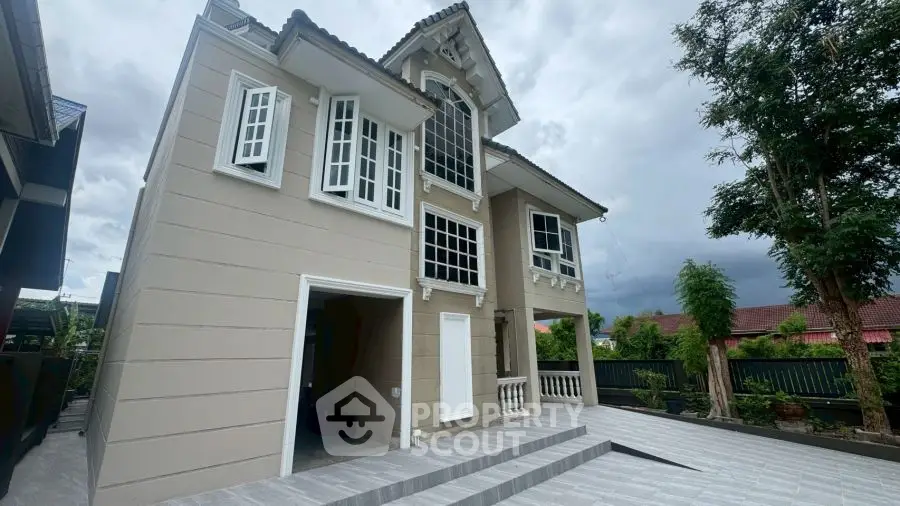 Stunning modern two-story house with elegant architecture and spacious driveway.