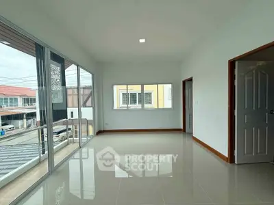 Spacious corner unit with large windows and balcony access, offering ample natural light and modern design.