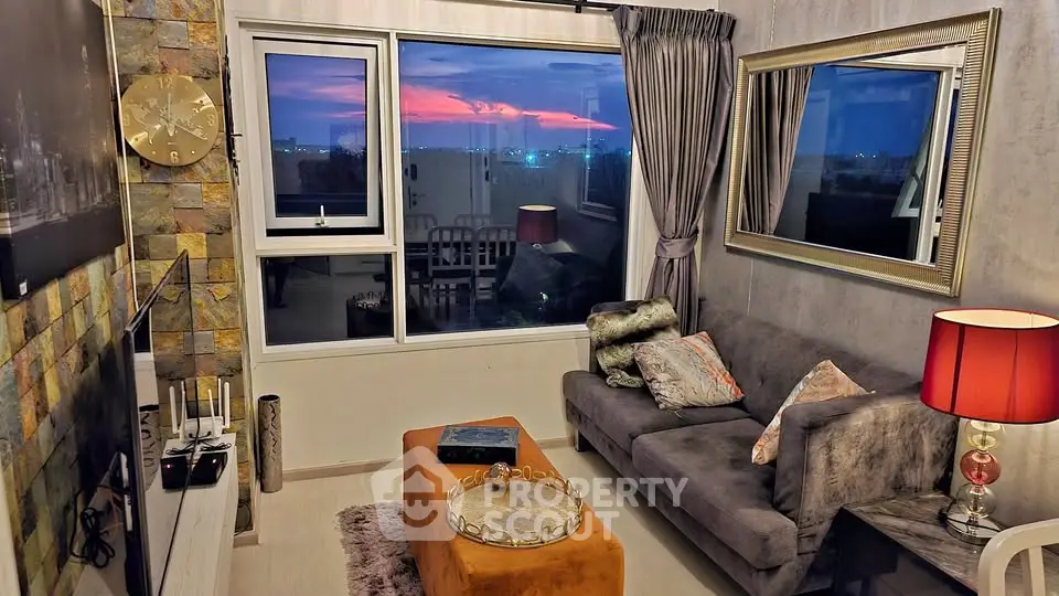 Chic living room with modern decor and stunning sunset view through large window.