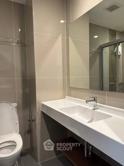 Modern bathroom with sleek design and large mirror