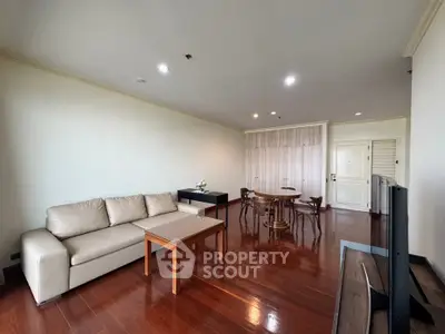Spacious living room with elegant wooden flooring and modern furniture