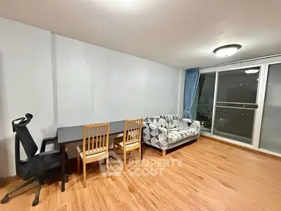 Spacious living room with modern furniture and large windows for natural light.