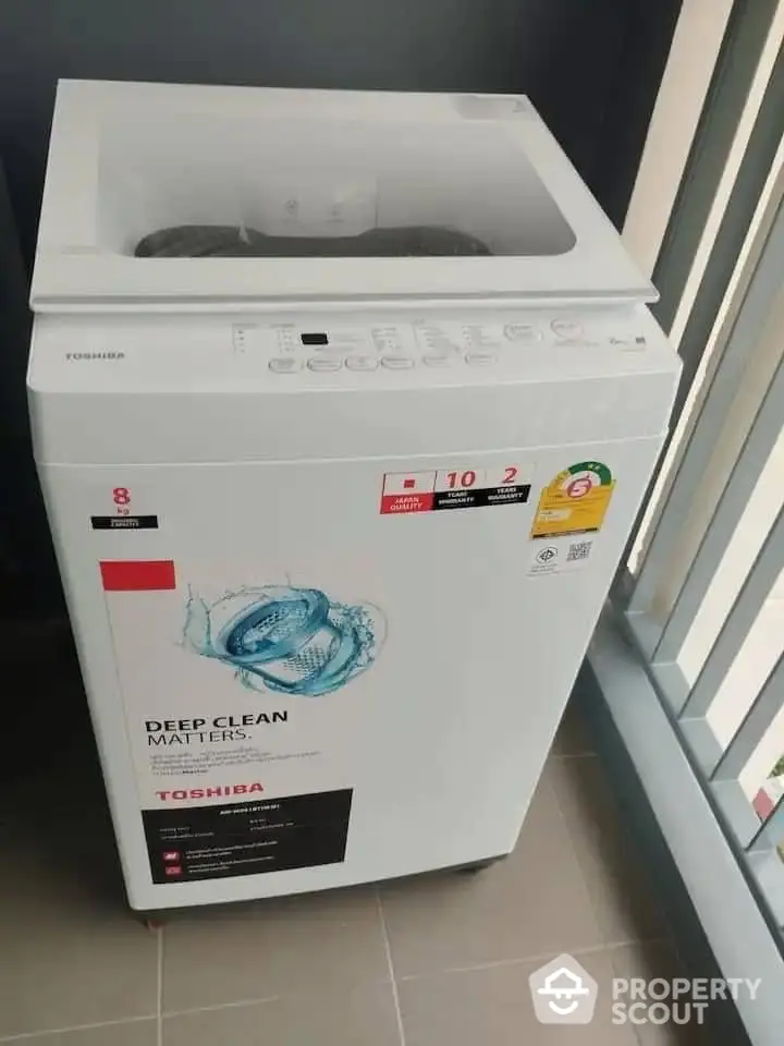 Modern Toshiba washing machine on balcony, perfect for urban living spaces.