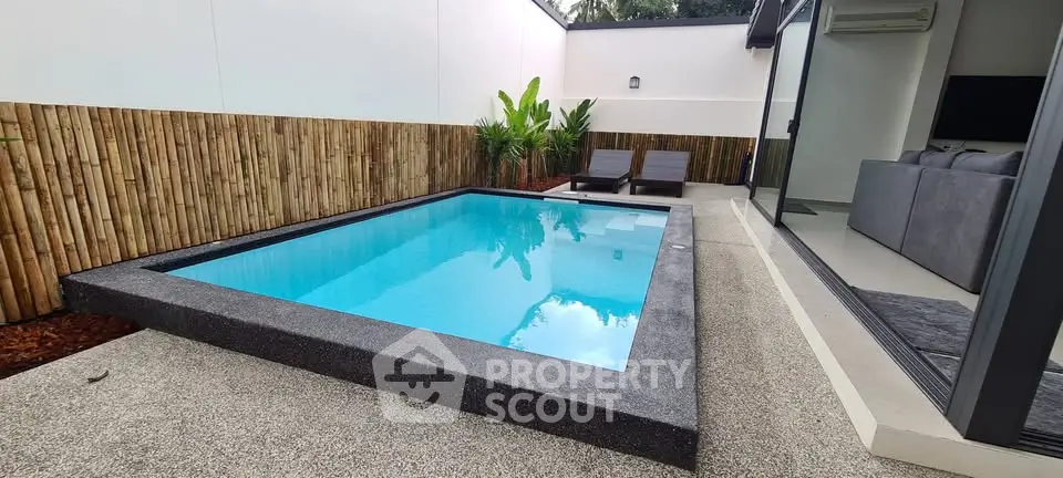 Modern home with sleek pool and stylish outdoor lounge area.