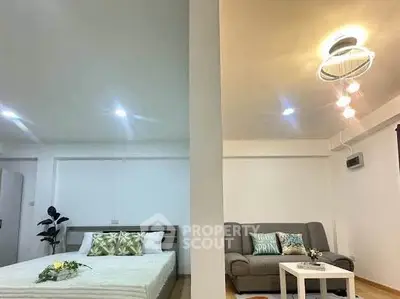 Modern studio apartment with cozy bedroom and stylish living area, perfect for urban living.