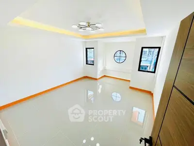 Spacious modern living room with large windows and elegant lighting