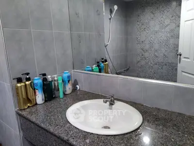 Modern bathroom with sleek sink and stylish tiled wall