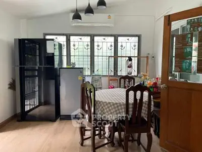 Charming kitchen with dining area, featuring modern appliances and natural light.