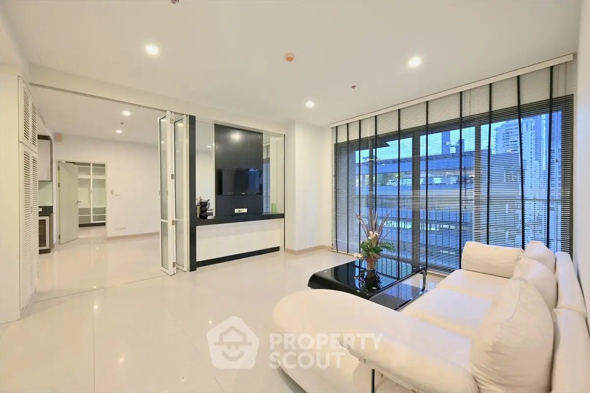 Spacious modern living room with large windows and city view