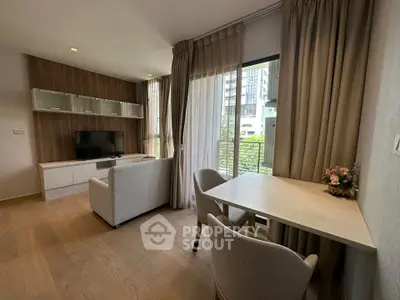 Modern living room with natural light, stylish furniture, and a view of the cityscape through large windows.