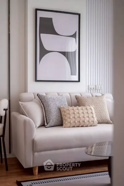 Stylish modern living room with elegant sofa and decorative pillows, perfect for cozy relaxation.