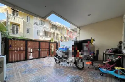 Spacious covered patio with tiled flooring and street view, ideal for outdoor relaxation or parking.