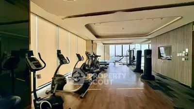 Luxurious high-rise gym with panoramic city views and modern fitness equipment.