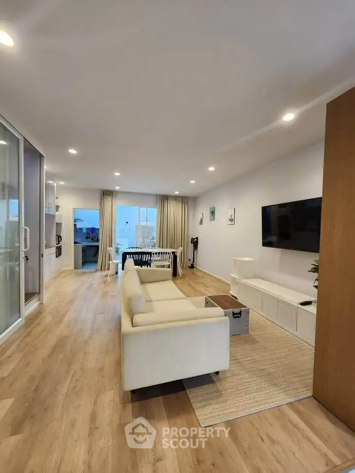 Spacious modern living room with elegant decor and large windows for natural light.