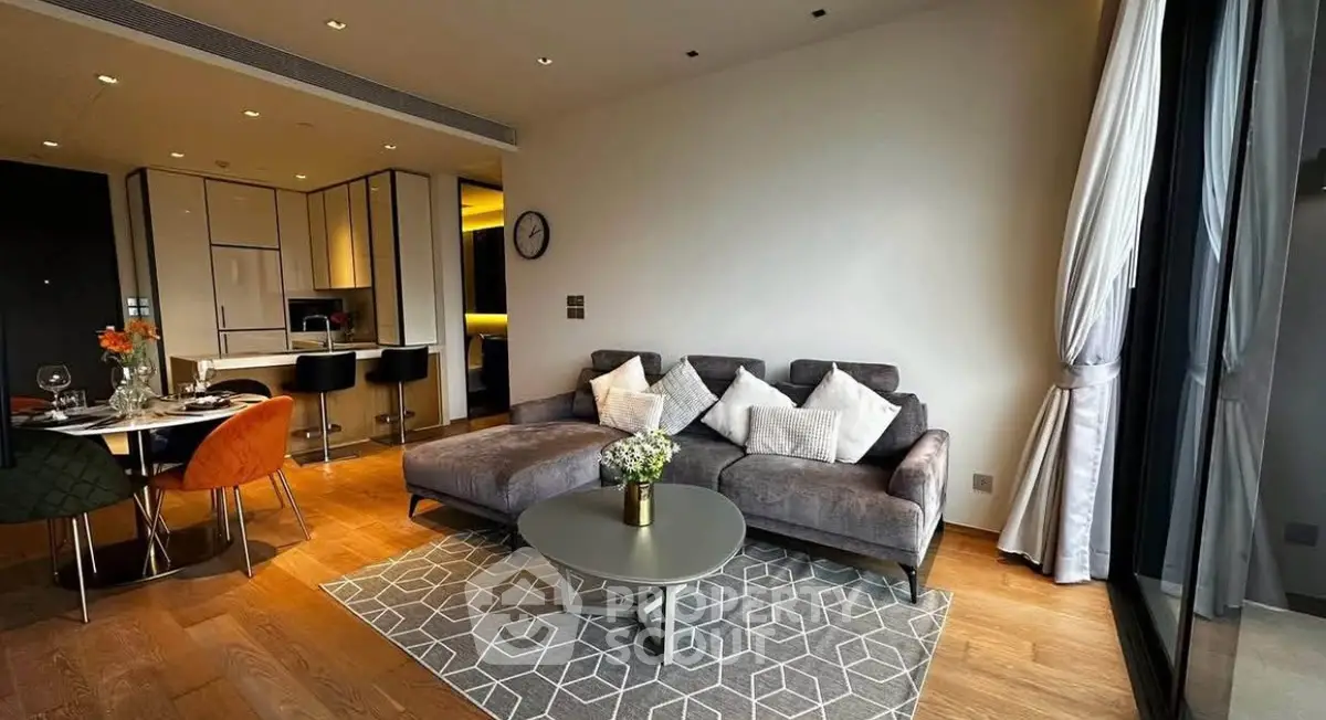 Modern living room with stylish furniture and open kitchen layout in a contemporary apartment.