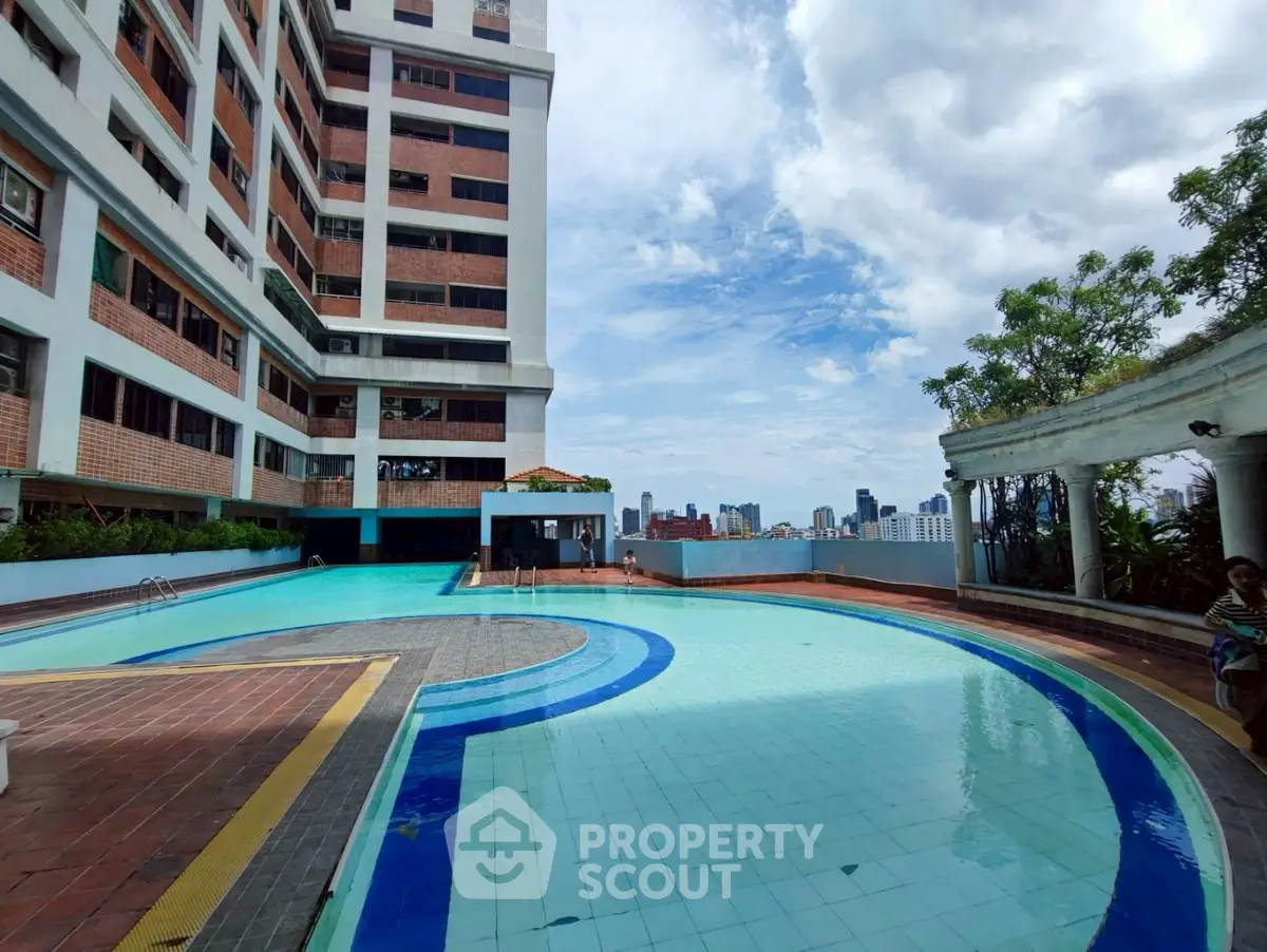 Stunning rooftop pool with city skyline views in a modern apartment complex.