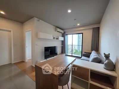 Modern living room with sleek furniture and city view balcony in a stylish apartment.