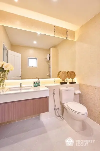 Modern bathroom with elegant fixtures and large mirror in a luxury home.