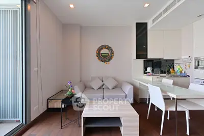 Modern living room with sleek furniture and open kitchen layout