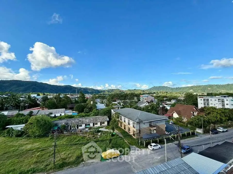 Scenic view of suburban neighborhood with lush greenery and mountains