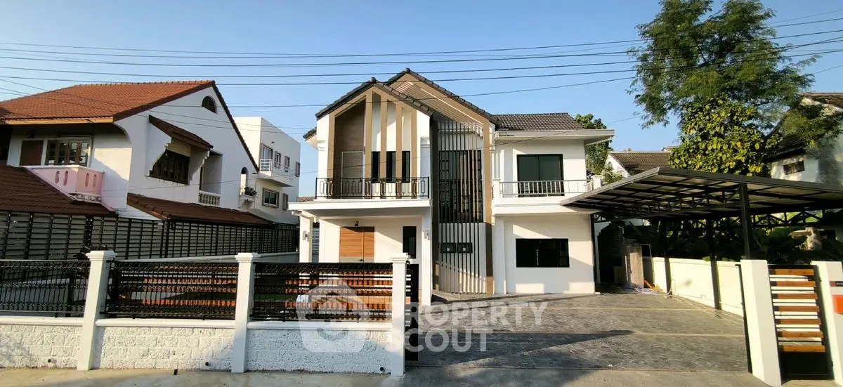 Modern two-story house with spacious driveway and contemporary design.