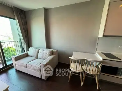 Modern living room with cozy sofa and dining area in a bright apartment.