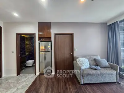 Modern living room with cozy sofa and sleek kitchen area in stylish apartment