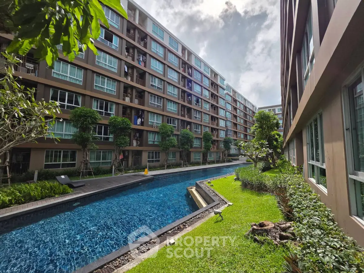 Modern condominium with pool and lush garden, offering a serene urban living experience.