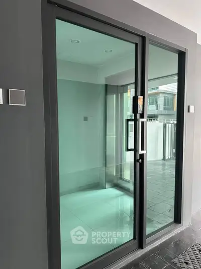 Modern glass entrance with sleek design and contemporary architecture