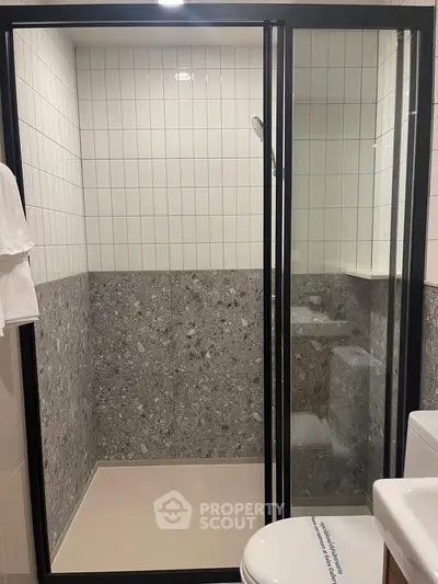 Modern bathroom with sleek shower enclosure and stylish tile design.