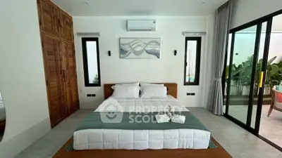 Modern bedroom with large windows and poolside view, featuring elegant decor and ample natural light.