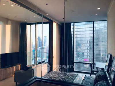 Modern bedroom with city view and stylish decor in high-rise apartment.