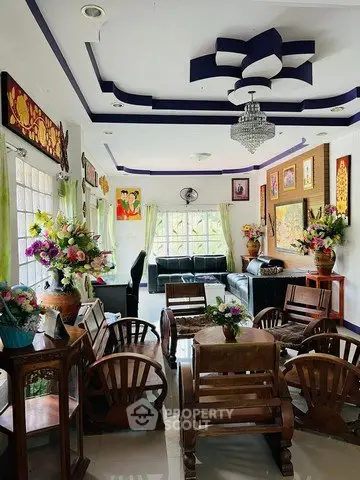 Charming living room with elegant decor, vibrant floral arrangements, and cozy seating, perfect for relaxation and entertaining.