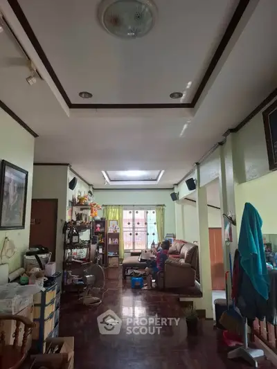 Spacious living room with cozy seating and natural light, perfect for family gatherings.