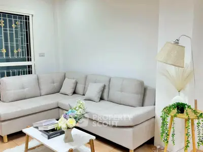 Charming living room with cozy beige sectional sofa and stylish decor