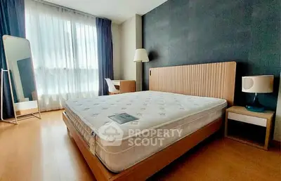 Spacious bedroom with modern furnishings and natural light