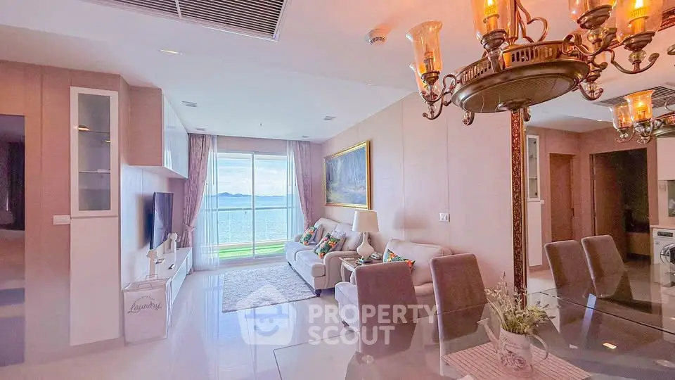 Luxurious living room with stunning ocean view, elegant chandelier, and modern decor in a high-end apartment.