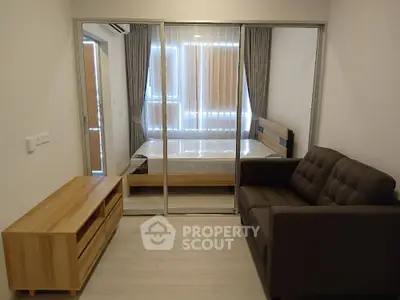 Modern bedroom with glass sliding doors and cozy sofa